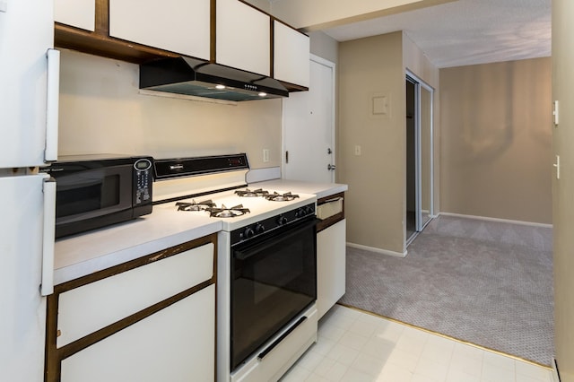 kitchen with white gas range, light carpet, and white cabinets