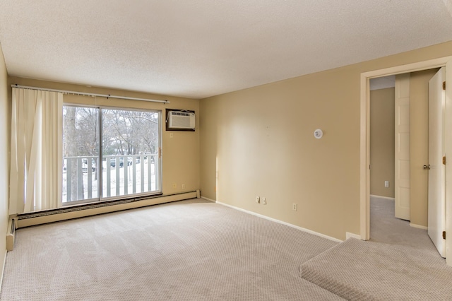 empty room with a textured ceiling, an AC wall unit, light carpet, and a baseboard heating unit