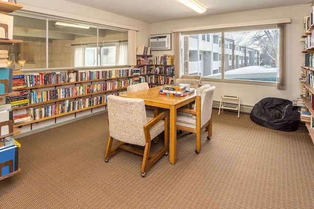 dining room featuring a wall unit AC, carpet flooring, and a baseboard heating unit