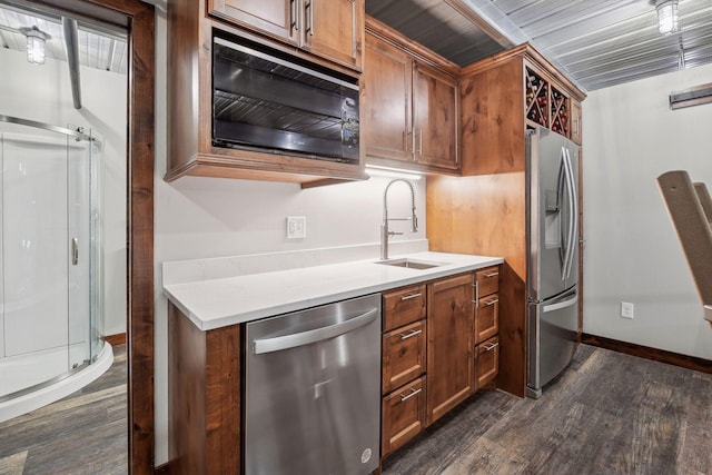 kitchen with dark hardwood / wood-style flooring, sink, and appliances with stainless steel finishes