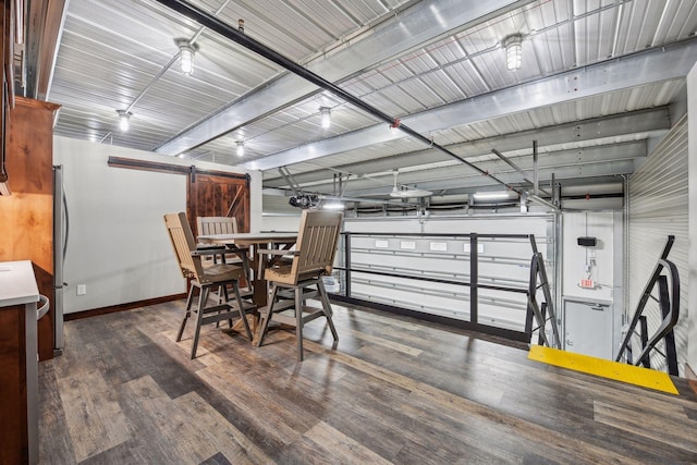 dining area with dark hardwood / wood-style floors and a barn door