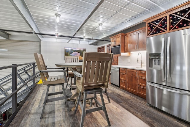 kitchen with sink, hanging light fixtures, dark hardwood / wood-style floors, and appliances with stainless steel finishes