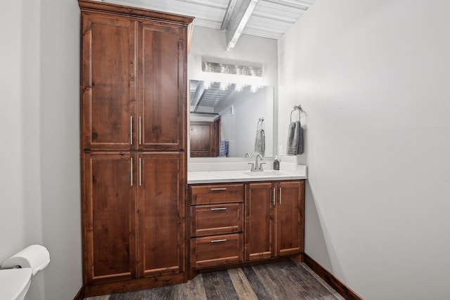 9200 Nike Road 31 & 47, Minnetrista, MN 55359 - bathroom featuring wood finished floors, vanity, toilet, beam ceiling, and baseboards