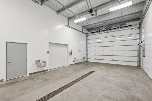 garage featuring sink and a garage door opener