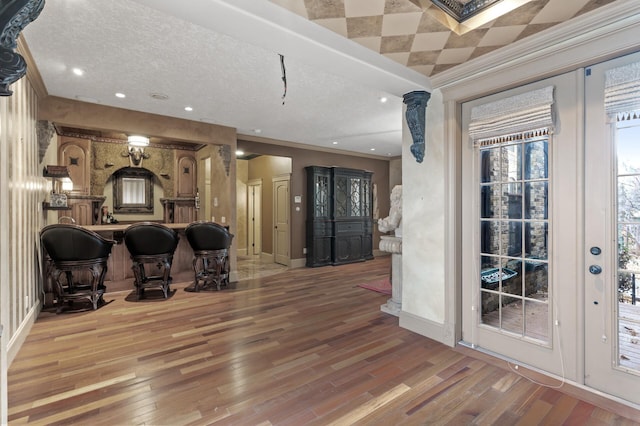 interior space featuring light wood-type flooring and ornamental molding