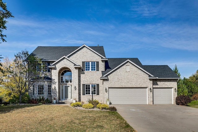 view of front of house featuring a garage and a front lawn