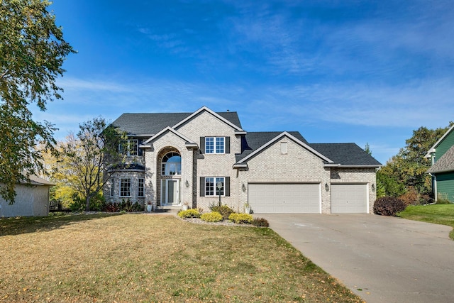 view of front of property with a front lawn and a garage