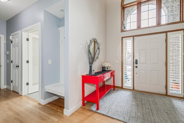 entrance foyer with hardwood / wood-style floors, a textured ceiling, and a wealth of natural light