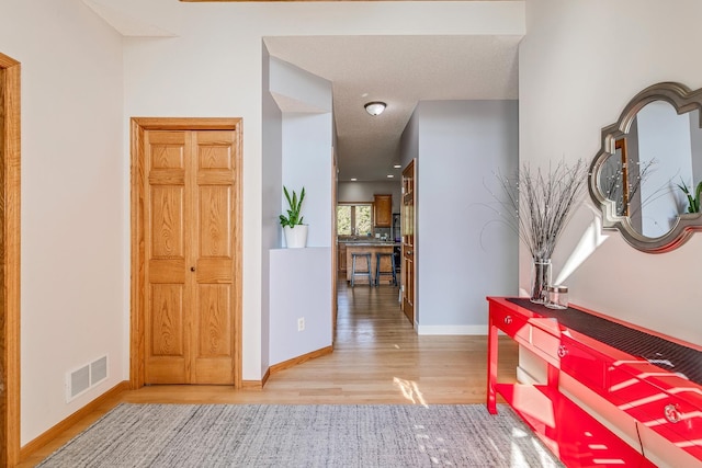 hall with hardwood / wood-style flooring