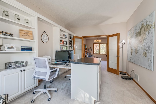 carpeted office featuring a notable chandelier, built in features, a textured ceiling, and french doors