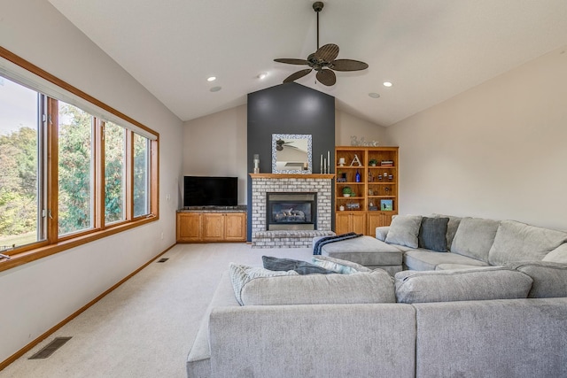 living room with ceiling fan, light colored carpet, lofted ceiling, and a fireplace