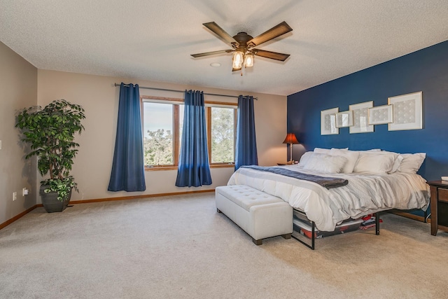 carpeted bedroom featuring a textured ceiling and ceiling fan