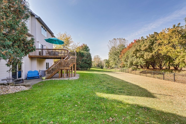 view of yard featuring a deck and central AC unit