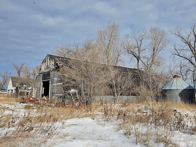 view of snowy exterior featuring an outdoor structure