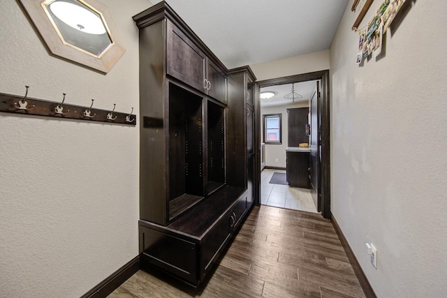 corridor with hardwood / wood-style flooring