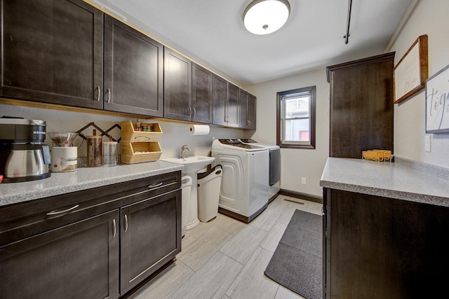 clothes washing area with cabinets and washing machine and clothes dryer