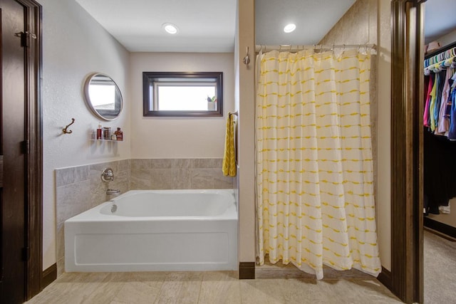 bathroom featuring separate shower and tub