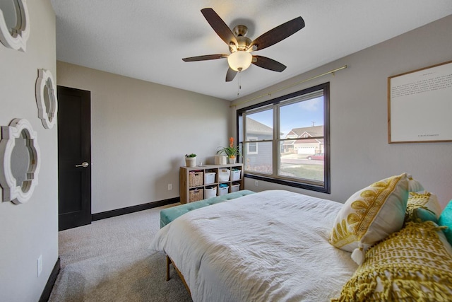 bedroom featuring ceiling fan and carpet