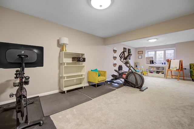 exercise room featuring dark carpet