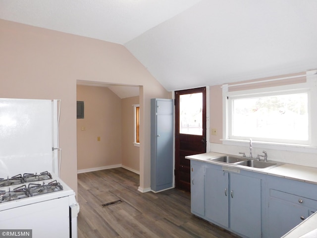 kitchen with lofted ceiling, white appliances, dark wood-type flooring, blue cabinets, and sink