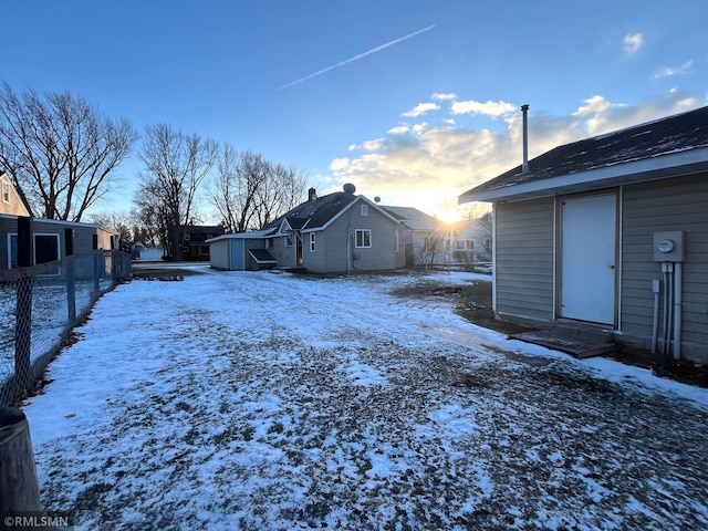 yard covered in snow featuring a storage shed