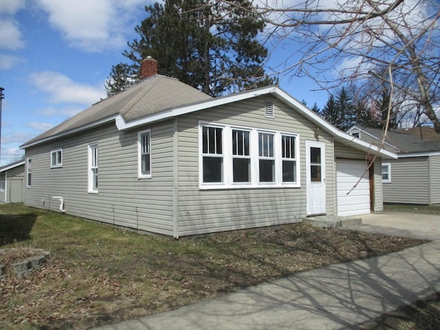 view of side of home featuring a garage