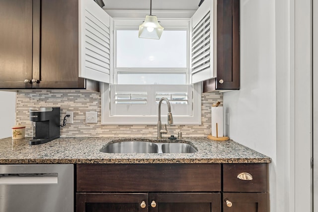 kitchen featuring dishwasher, sink, decorative backsplash, decorative light fixtures, and light stone counters