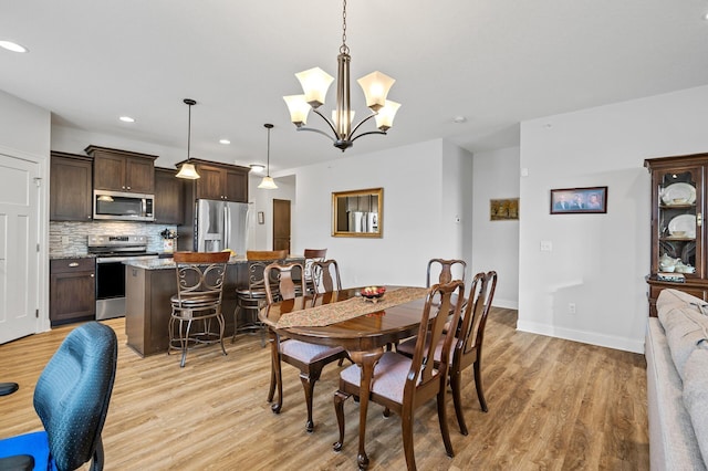 dining area featuring a chandelier and light hardwood / wood-style flooring