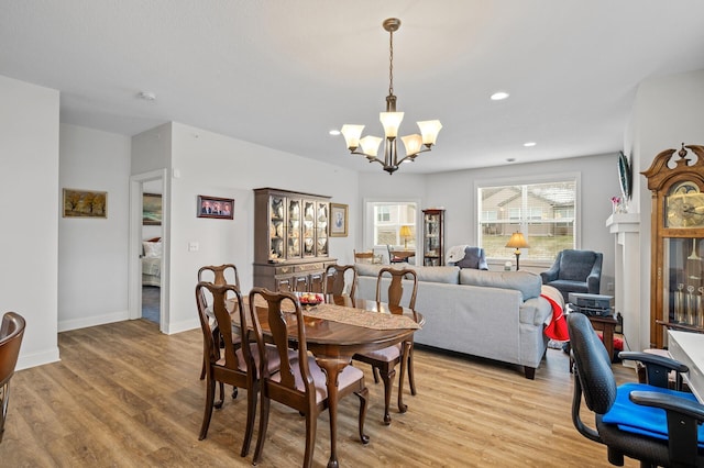 dining room featuring a chandelier and light hardwood / wood-style flooring