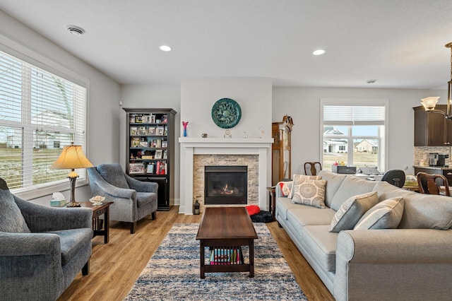 living room featuring a chandelier and light hardwood / wood-style flooring