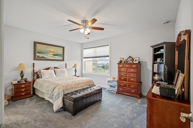 bedroom featuring ceiling fan, carpet floors, and a textured ceiling