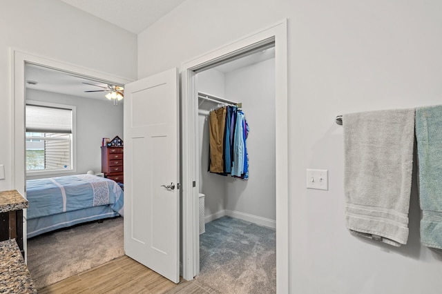 bedroom featuring hardwood / wood-style flooring, a closet, and ceiling fan