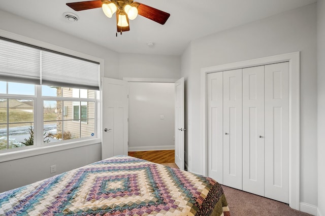 bedroom featuring ceiling fan, a closet, and carpet