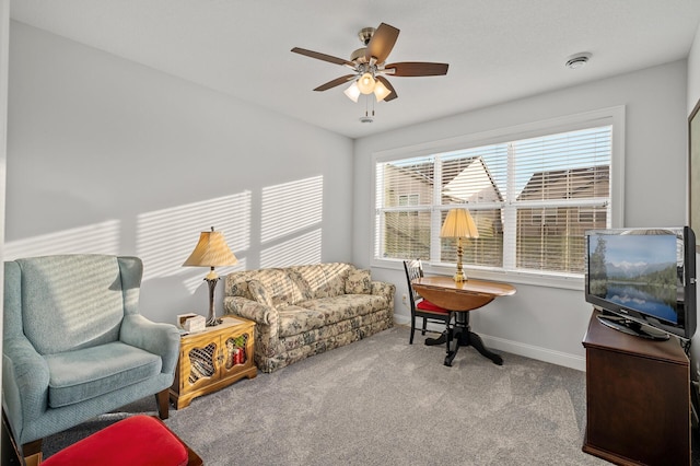 carpeted living room with ceiling fan