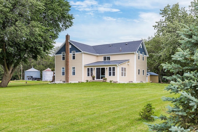 back of house with a yard