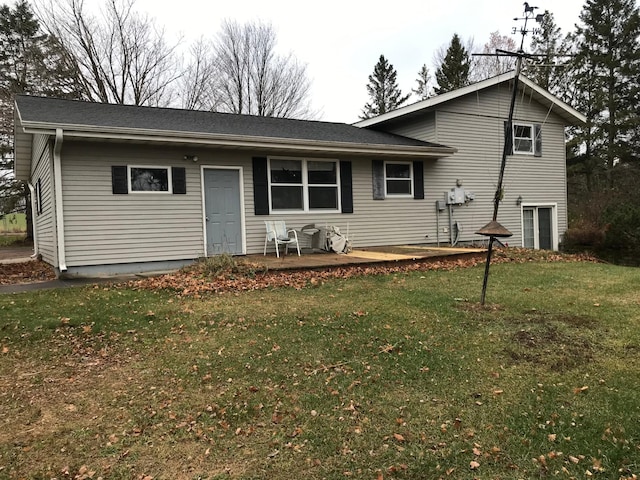 rear view of property featuring a yard