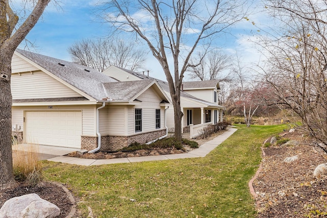 view of property exterior featuring a porch, a garage, and a yard