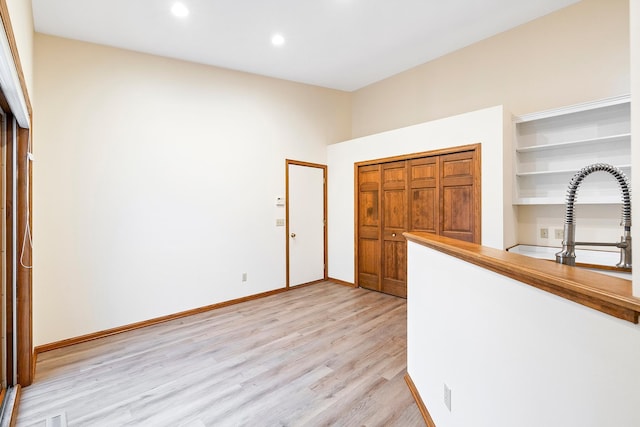 interior space featuring sink and light wood-type flooring