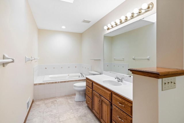 bathroom with tile patterned floors, vanity, a relaxing tiled tub, and toilet