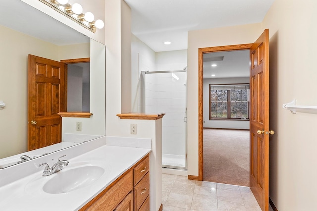 bathroom with tile patterned floors, vanity, and a shower with shower door