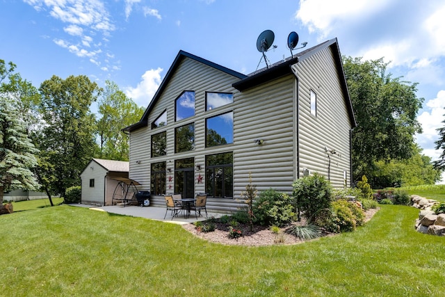 back of house featuring a yard, log veneer siding, and a patio area