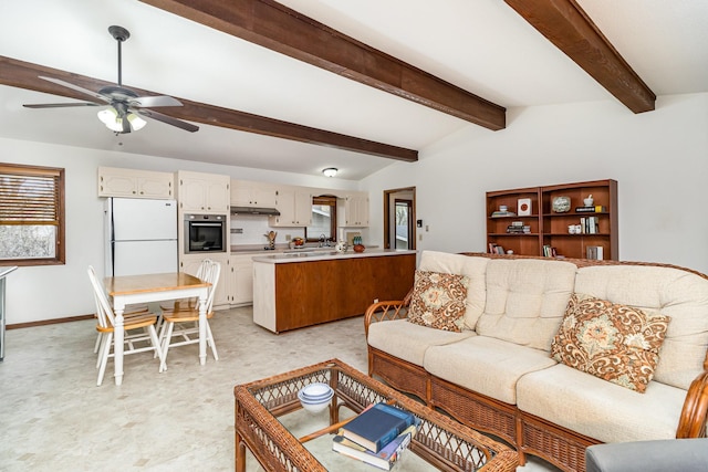 living room featuring light floors, a wealth of natural light, baseboards, and a ceiling fan