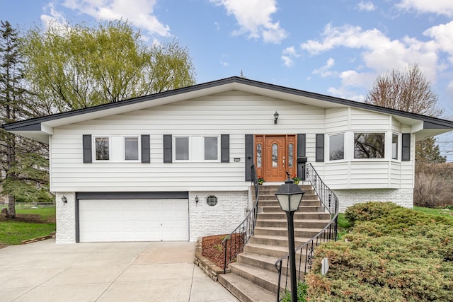 3507 Maplewood Dr, Saint Anthony, MN 55418 - view of front facade with an attached garage, concrete driveway, and brick siding