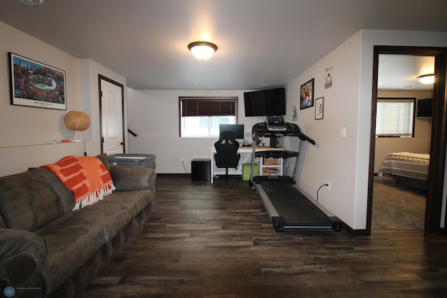 workout room with dark wood-type flooring