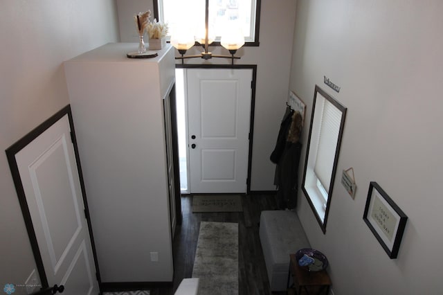 foyer featuring an inviting chandelier and dark hardwood / wood-style floors