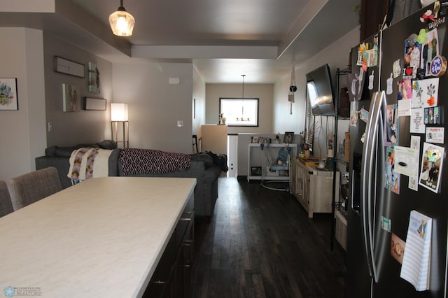 kitchen featuring stainless steel refrigerator with ice dispenser, dark hardwood / wood-style flooring, and decorative light fixtures