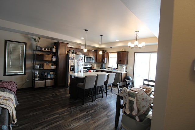 interior space with sink, a notable chandelier, dark hardwood / wood-style floors, and a raised ceiling