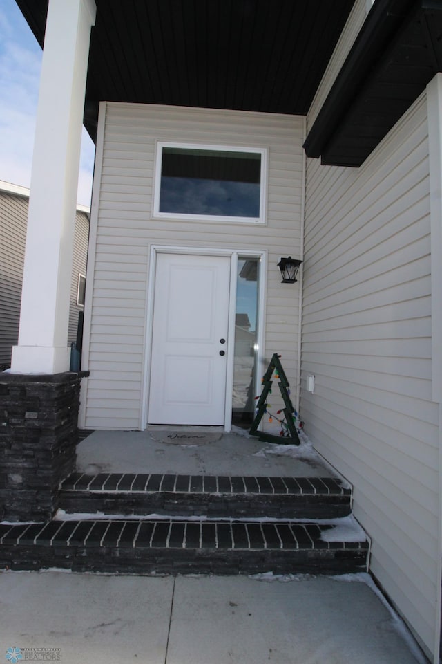 view of exterior entry featuring a porch