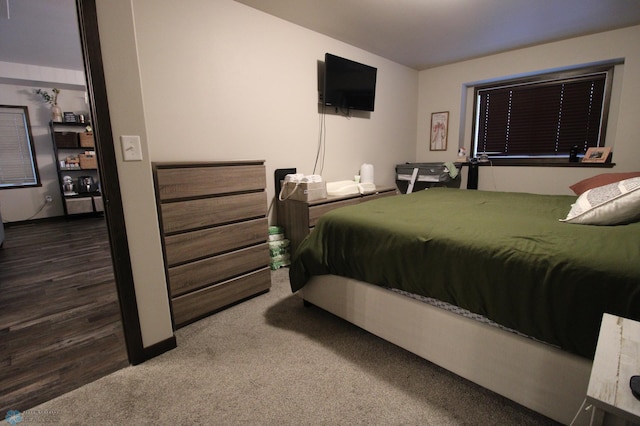 bedroom featuring dark carpet