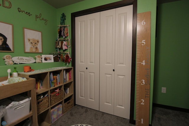 playroom featuring dark colored carpet